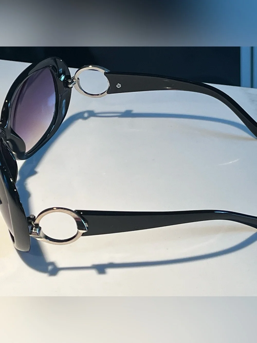 NWT fabulous oversized black sunglasses with violet lenses.